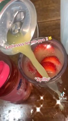 two plastic cups with strawberries and yogurt in them