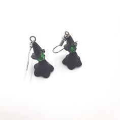 These witch earrings are a must-have accessory for any lover of the dark and magical. Handmade with 4mm black beaded pieces, green bead head, and silver ear-wire, these earrings are a simple yet stylish addition to any Halloween outfit. Whether you're attending a party or just looking to add some spooky flair to your everyday look, these earrings are a perfect choice. Don't miss out on this must-have accessory for the season of the witch! 🪄 Free shipping on all orders $35 or above 🪄 Each piece Black Single Earring For Halloween, Witchy Drop Earrings, Nickel-free Black Spooky Earrings, Spooky Black Drop Earrings, Green Halloween Party Earrings, Witchy Black Nickel-free Earrings, Green Halloween Dangle Earrings, The Season Of The Witch, Beautiful Birthday Cards