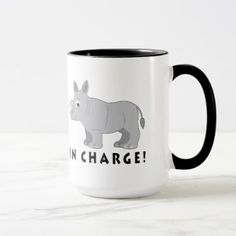 a rhinoceros coffee mug with the words i'm charge on it