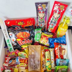 a box filled with lots of different types of snacks and candy bar wrappers on top of each other