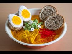 there are crocheted food items in the bowl