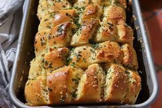 freshly baked bread with herbs in a baking pan