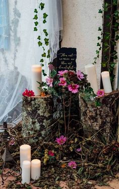 candles and flowers are placed on the ground