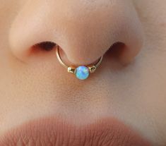 a woman's nose with an ope piercing in the shape of a ring