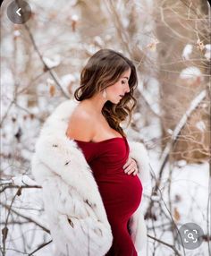 a pregnant woman in a red dress and fur coat