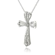 This attractive necklace displays a shimmering ribbon cross. It is crafted of sterling silver and features white topaz stones. The pendant hangs from an 18 inch rolo chain and is secured by a spring-ring clasp. Total topaz weight .75ct. Product Details Metal Type sterling-silver Metal Stamp 925-sterling Weight 3.3GR Length 18IN Width 21.5MM Height 28MM Clasp Type spring-ring Chain Type rolo Chain Length 18 Stone Details Gem Type topaz Number of Stones 28 Stone Color white Stone Shape round-shape Sterling Silver Pave Setting Cross Pendant Jewelry, Diamond Accented Cross Pendant Jewelry For Anniversary, Silver Cross Jewelry With Single Cut Diamonds, Diamond Accented Cross Pendant For Anniversary, Sterling Silver Cross Pendant Diamond Necklace For Anniversary, Sterling Silver Cross Pendant With Pave Setting, Anniversary Jewelry With Diamond Accents On Cross Pendant, Silver Heart Pendant Jewelry With Pave Setting, Sterling Silver Heart Pendant Jewelry With Pave Setting