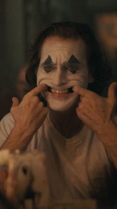 a man with his face painted as the joker