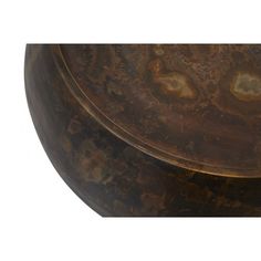 a round wooden table with brown and gold paint