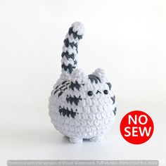 a crocheted stuffed animal with black and white stripes