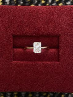 a diamond ring in a red velvet box