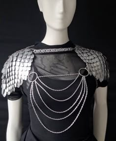 This bold scalemail armor and chainmail body chain shoulder armor spaulders set is perfect for any snake, fairy, mermaid, or dragon cosplay or viking costume, or for Renaissance Fair,  outfits, weddings, or music festivals or concert outfits. With adjustable neck and back straps, you'll be ready to conquer whatever adventure you choose. THIS IS NO ORDINARY SCALEMAIL TOP! IT IS PREMIUM CHAINMAIL CRAFTED BY A SKILLED ARTISAN IN CANADA! Fashioned from top-grade stainless steel rings and chains and Scalemail Armor, Dragon Cosplay, Warrior Fashion, Outfit Corset, Chainmail Top, Dragon Fairy, Rave Costume, Viking Dragon