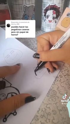 someone is drawing on paper with a marker