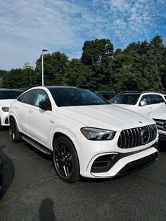 the mercedes gle coupe is parked in a parking lot with other cars behind it