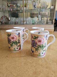 three coffee cups sitting on top of a counter