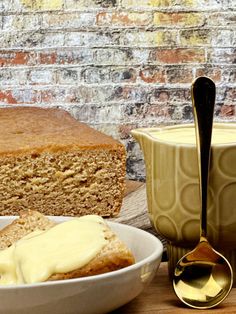 a loaf of bread sitting on top of a table next to a bowl of butter