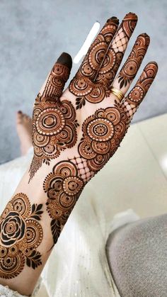 the hand is decorated with henna and flowers