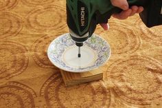 a person using a drill to fix a plate