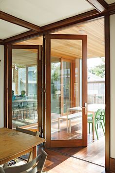 the inside of a house with wooden floors and sliding glass doors