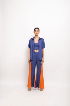 Blue-Orange three piece co-ord set; blue halter neck bustier paired with blue-orange panelled shirt and blue-orange panelled flared pants.Party Wear, Casual, Office Wear, Day Wear, Holiday Wear Fabric : Bemberg Modal Silk Blue-Orange Color Butter Crepe Lining Colorblocked Pattern 7-14 days Delivery Dry clean only Summer Blue Pant Set With Short Sleeves, Blue Two-piece Sets With Short Sleeves, Blue Short Sleeve Pant Set For Summer, Blue Wide Leg Summer Sets, Party Wear Casual, Orange Color Block, High Waisted Flare Pants, Casual Office Wear, Holiday Wear