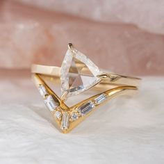 a close up of a gold ring with a diamond on it's center piece