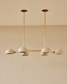 three lights hanging from the ceiling in a room