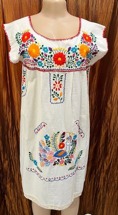 This fabulous 100% Cotton Puebla Style Dress is hand made and hand embroidered with bright floral design!  The sleeves and hem has natural crocheted trim at the edge of sleeve and hem!  Great spring and summer top as well as topping it off with a jean jacket, kimono or poncho for the fall! This fabric looks is not the thin fabric of the normal Puebla dress! Measurements! Pic 1: Small Chest 36" Length 39" Pic 2:  Small Chest 36" Length 40 1/2" Care: Cold wash, delicate, inside out! Hang dry Do no Puebla Dress, Natural Dress, Nature Dress, Dress Measurements, Small Chest, Summer Top, Style Dress, Womens Clothing Tops, Jean Jacket