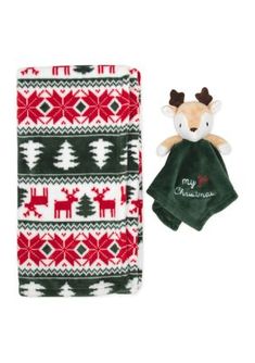 a green and red christmas towel next to a stuffed animal