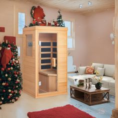 a living room with a christmas tree and a sauna in the corner next to a couch