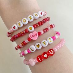 four bracelets with love written on them and hearts in the middle, including one for xoxo