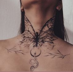 a woman with a butterfly tattoo on her back and neck is looking up at the sky