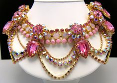 "Massive Showstopper Bib Necklace Earring Set Opalescent AB Pink Rhinestone Glass Marked Show Must Go On. Marked on All Three Pieces \"Show Must Go On\". The Necklace is Approximately 20\" Long and 3\" Wide. Earrings are Clip Backed and Measure 1 3/8\" Diameter. Condition is Excellent with No Flaws and Minimal Wear or Aging...appears never worn. I will be listing another pair of earrings that match this set separately if you prefer dangle earrings." Pink Jeweled Rhinestone Necklace For Party, Pink Rhinestone Jeweled Necklace For Parties, Pink Crystal-embellished Jewelry For Party, Pink Crystal Embellished Jewelry For Party, Pink Crystal Jewelry With Jewels, Pink Rhinestone Necklace For Party, Jeweled Crystal Dangle Jewelry, Crystal Jeweled Dangle Jewelry, Crystal Dangle Jewelry With Jewels