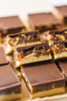 several pieces of chocolate and nuts on a cutting board