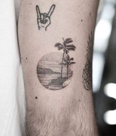 a man with a tattoo on his arm has a palm tree and an island in the background