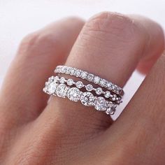 a woman's hand with three rings on it