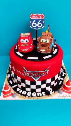 a birthday cake with cars on it and a route 66 sign