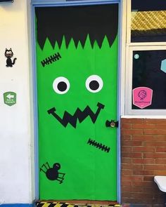 a green door decorated to look like a monster