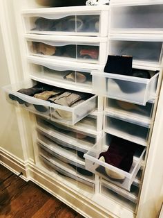 the closet is full of shoes and other items in plastic bins on the shelves