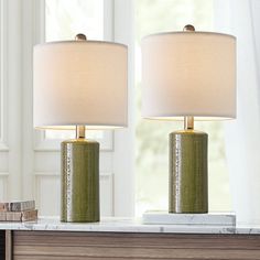 two lamps sitting on top of a table