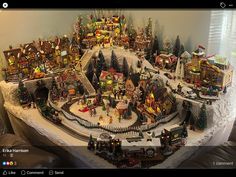 a christmas village is displayed on a table