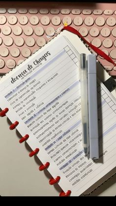 an open notebook sitting on top of a computer keyboard