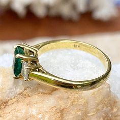 Vintage/ antique 18KT yellow gold emerald-cut Colombian emerald + diamond accent ring. Absolutely stunning and high quality ring which would be fantastic as an engagement, birthstone, or celebration piece. Size 9 Can be resized for an additional fee 1.25 CT plus natural, Colombian emerald Emerald measures: 7mm x 5.3mm Inclusions in stone, but deep color and saturation 2 natural, emerald-cut, natural diamonds VS clarity; H color diamonds .50 CTW diamonds Weight: 4.65 grams Estate condition. 1 Sid Heirloom Emerald Ring Baguette Cut, Heirloom Style Baguette Cut Emerald Ring, Heirloom Baguette Cut Emerald Ring, Gift Emerald Ring With Three Stones In Radiant Cut, Gold Emerald Ring With Radiant Cut, Gold Radiant Cut Emerald Rings, Yellow Gold Radiant Cut May Birthstone Ring, Yellow Gold Radiant Cut Ring For May Birthstone, Heirloom Emerald Wedding Ring, Baguette Cut