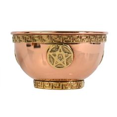 a large metal bowl with an intricate design on the side and gold trimmings