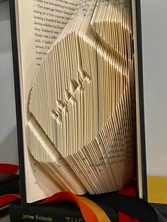 an open book that has been folded into the shape of a man's face