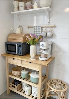 a small kitchen with a microwave, coffee maker and other items on the counter top