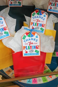 some paper bags with thank you for playing on them