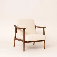 a white chair sitting on top of a wooden frame