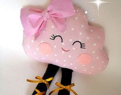 a stuffed animal with a pink bow on it's head and shoes hanging from the wall