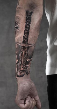 a man's arm with a knife tattoo on it