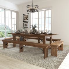 a dining room table and bench in front of large windows