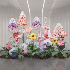 an arrangement of colorful flowers on display in a room